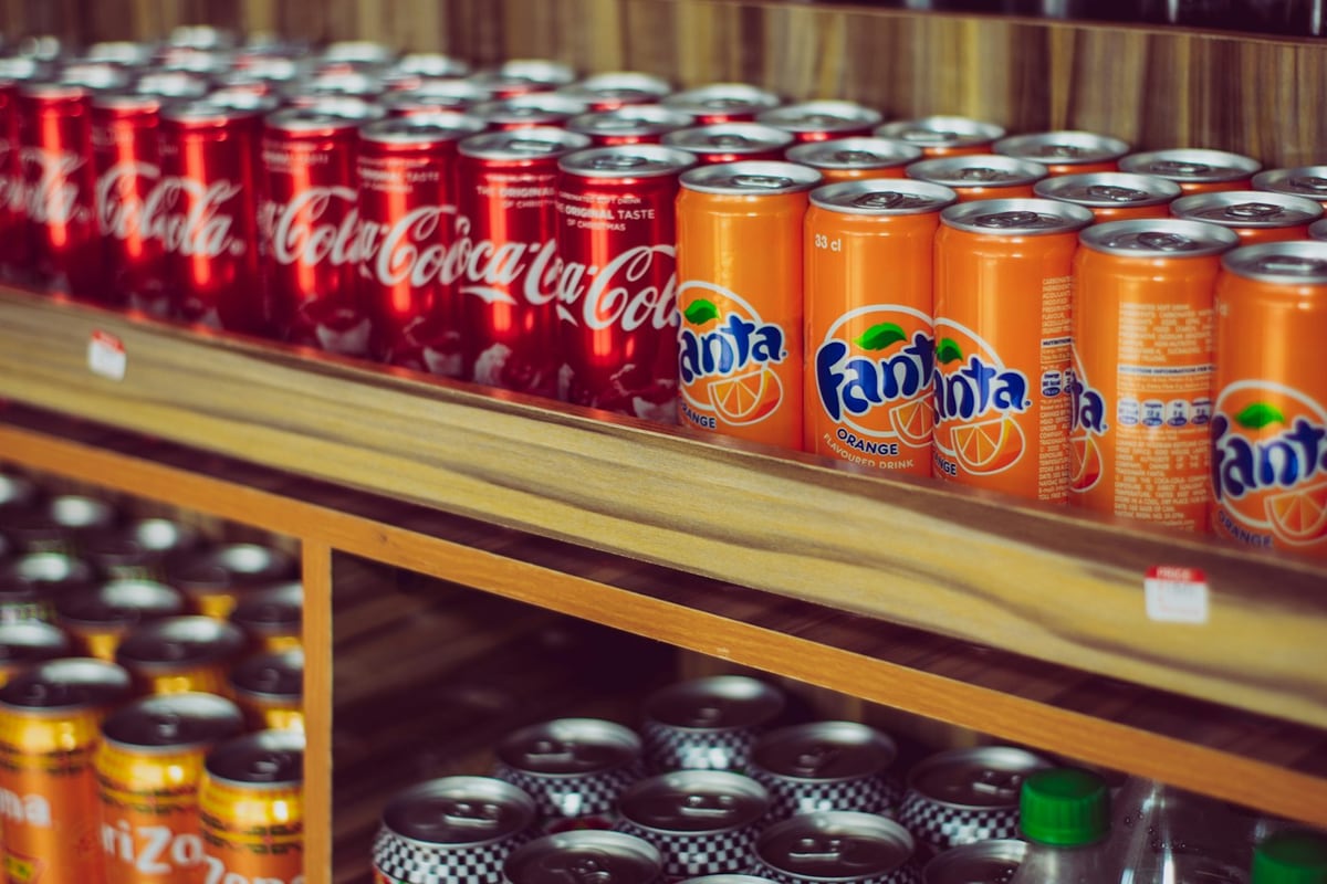 Rows of chilled Coca-Cola and Fanta cans