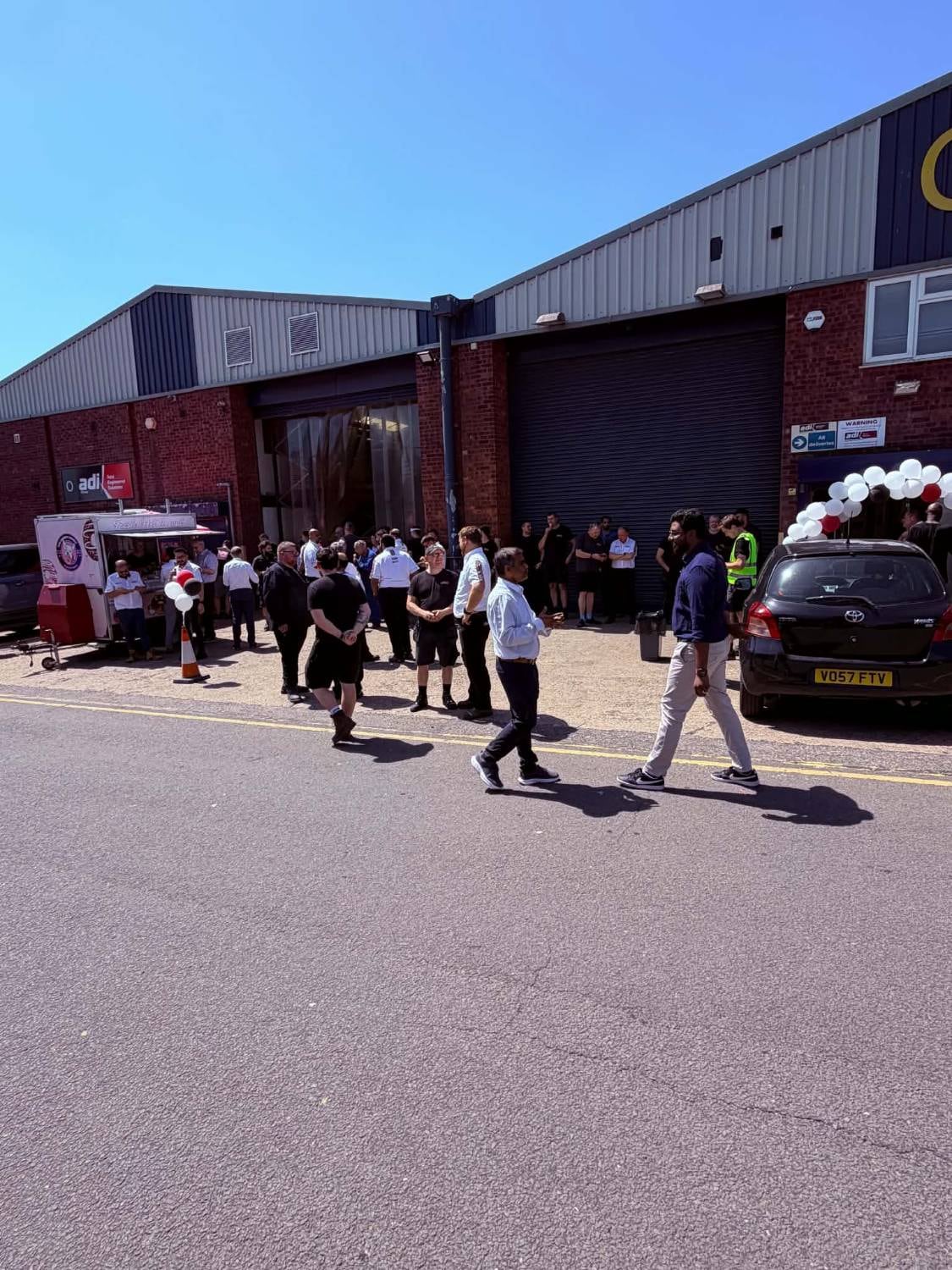 The Angry Donut trailer catering a busy corporate opening event outside a business unit