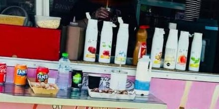 A row of chocolate and fruit sauce bottles ready for topping donuts on the Angry Donut counter
