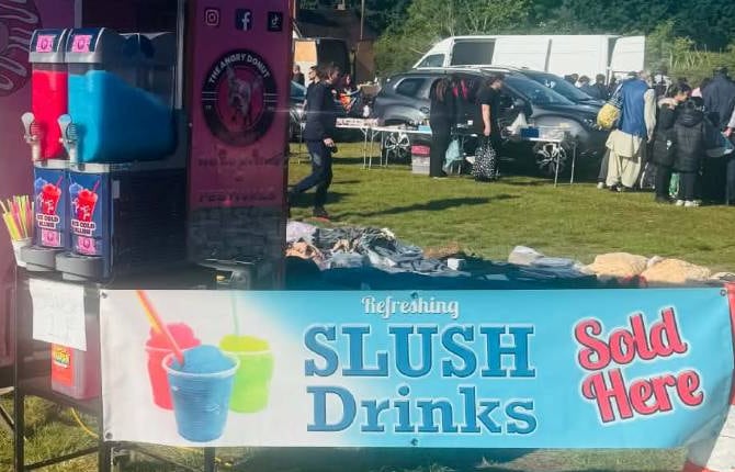 Red and blue slush machines next to a 'Refreshing Slush Drinks' banner