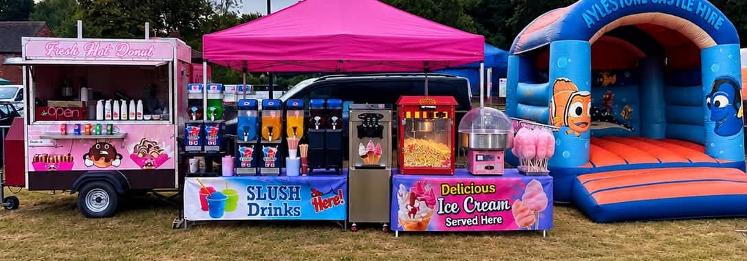 Panoramic view of the Angry Donut trailer and dessert stations at a fun day