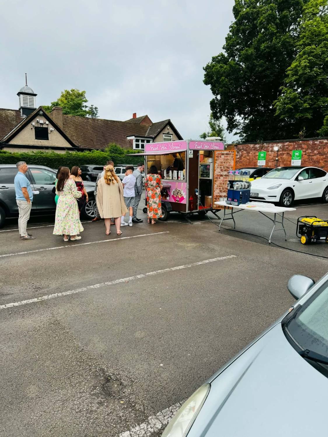 Smartly dressed guests queuing at the Angry Donut trailer at a private celebration